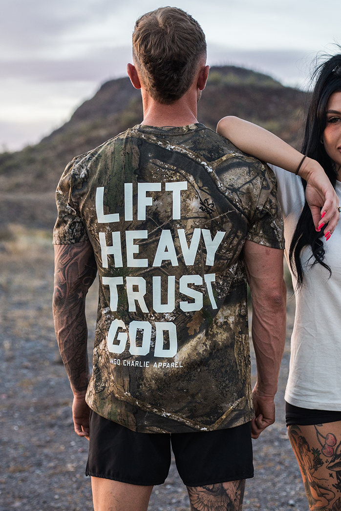 Lift Heavy. Trust God. - Realtree Premium Camo Tee UNISEX MENS